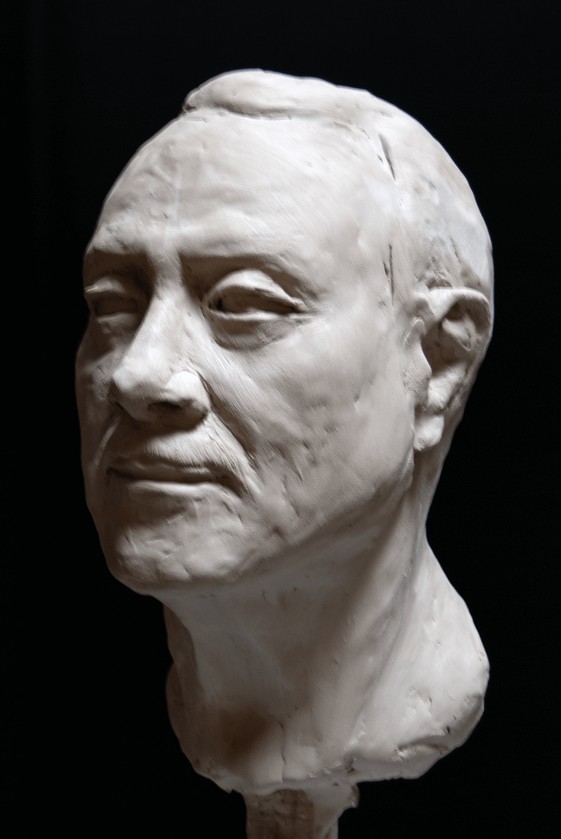 Quique  clay Sculpture portrait in 3/4 Black Background.