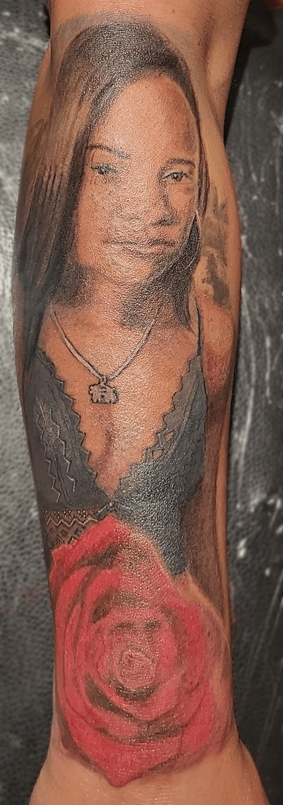 Bottom Half Sleeve Agatha portrait and rose color Tattoo on dark skin fresh in the studio