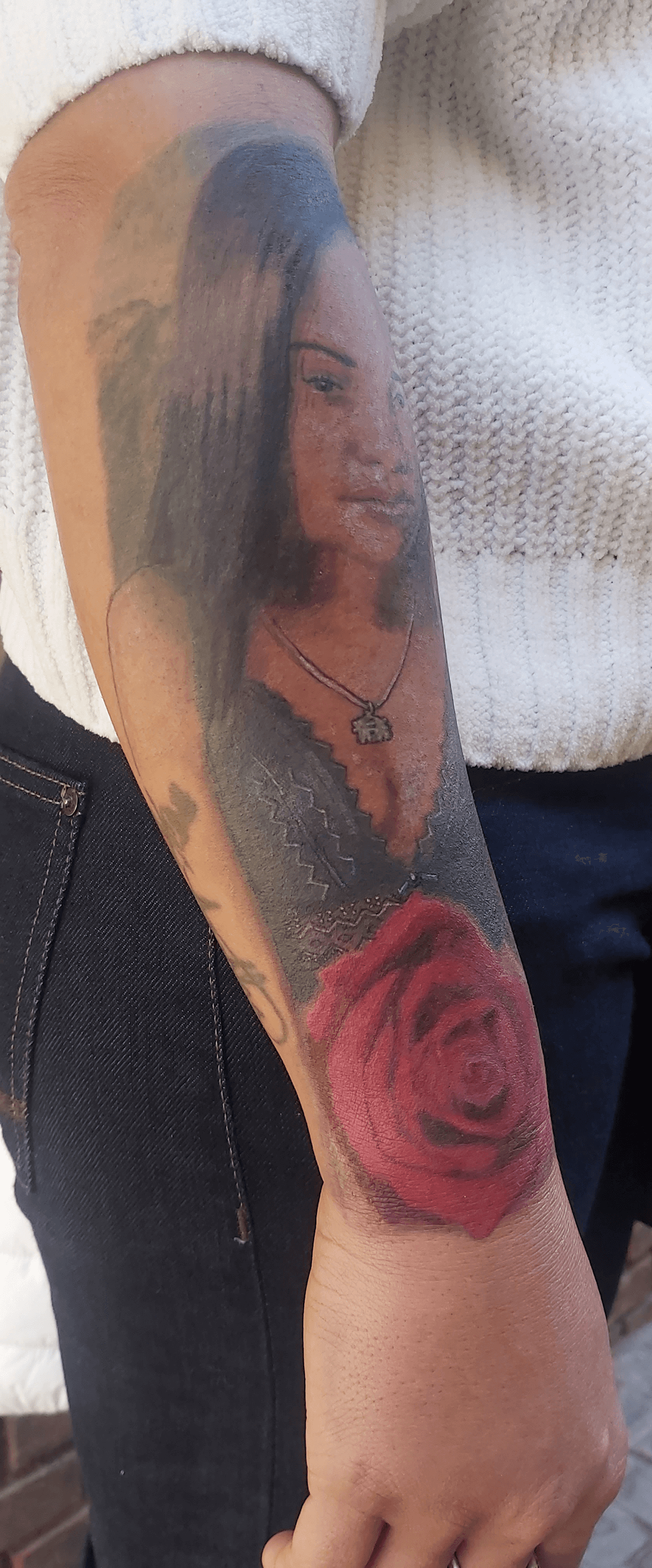 Bottom Half Sleeve Agatha portrait and rose color Tattoo on dark skin outdoor day after