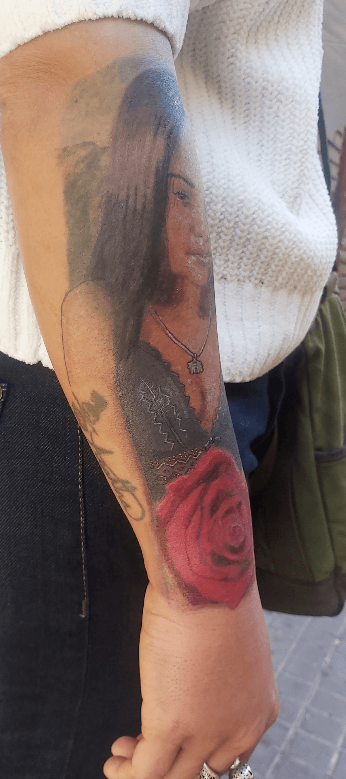 Bottom Half Sleeve Agatha portrait and rose color Tattoo on dark skin outdoor day after